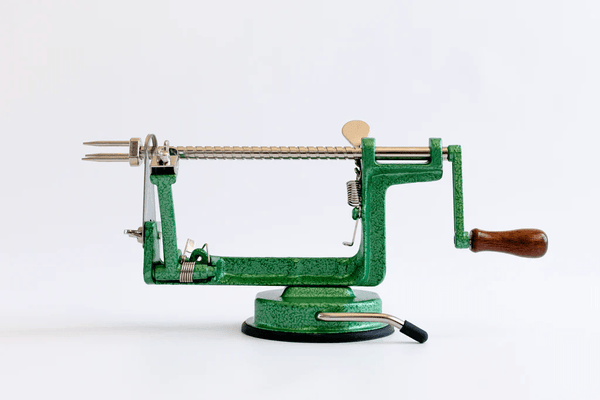 A green, all-in-one apple peeler, corer, slicer